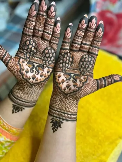 Another view of the detailed peacock design, showing how the pattern extends from the palm to the wrist.