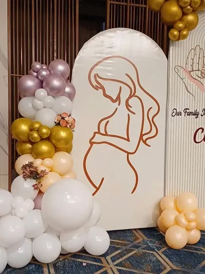 A close-up of the custom-printed panels for a modern baby shower. The line art of the mother and baby hands adds a personal and artistic touch to the decor.