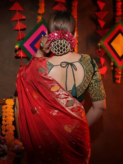 A view of the back of the blouse and the elegant floral bun, showing a complete traditional look.
