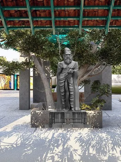 A central feature of the park is this courtyard with a statue, creating a focal point for cultural learning and reflection. The design uses the shade of a large tree to create a comfortable gathering space.