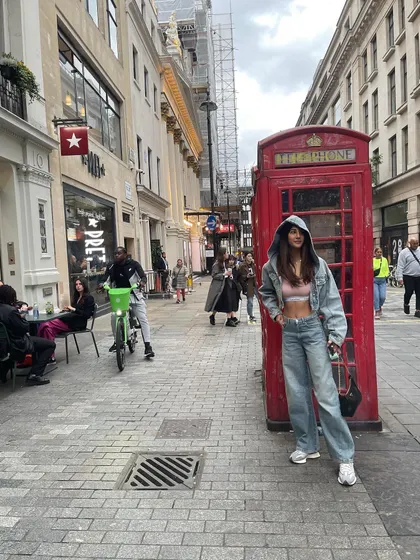 The key to a good travel outfit is comfort and style. This cropped denim hoodie and wide-leg jeans combination is one of my go-tos.