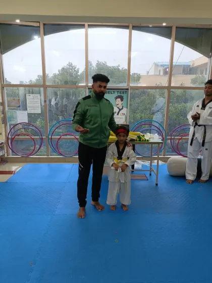 A young student after receiving his yellow belt.