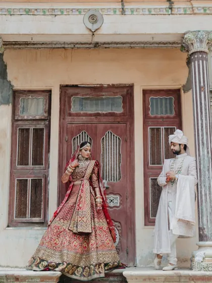 A grand, full-length portrait of the couple against a heritage backdrop, looking every bit like royalty.