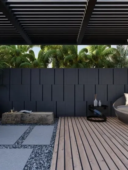 A private garden concept for a hotel suite in Ludhiana, designed for ultimate relaxation. The space includes a wooden deck with a daybed, an open-air shower with a water cascade, and lush tropical planting under a pergola.
