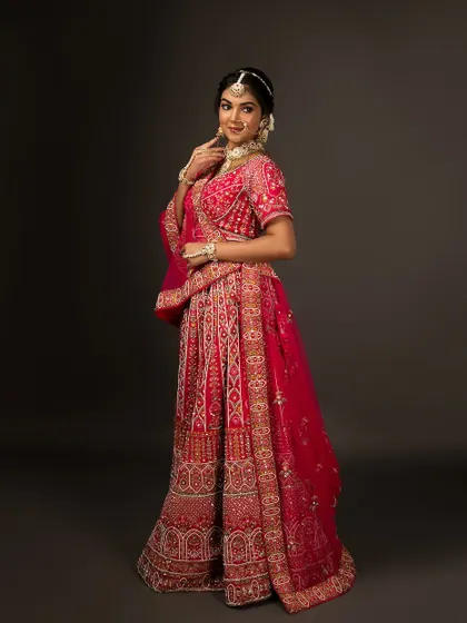 A full-length profile shot of the bridal lehenga, showing its beautiful flare and intricate details.
