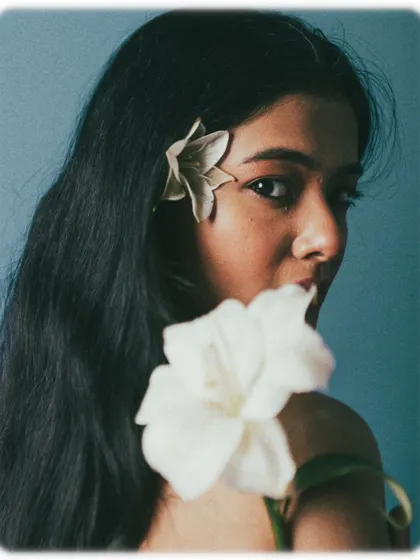 A duplicate of 147, this moody portrait uses flowers and dramatic lighting to create a mysterious and artistic feel.