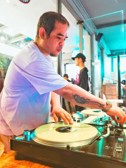 Two turntables and a whole lot of sass. A candid shot of me spinning some records and showing off my ink.
