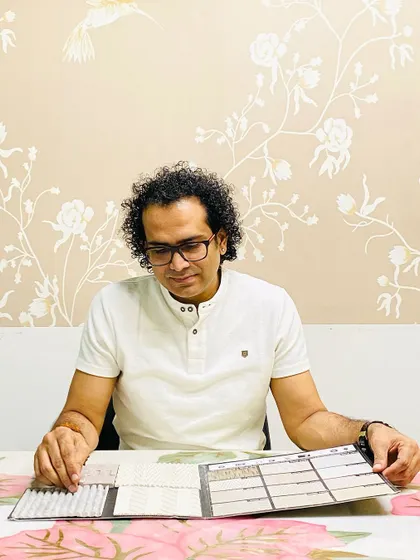 A photo of me selecting clay cladding samples, a durable and eco-friendly option for exteriors.