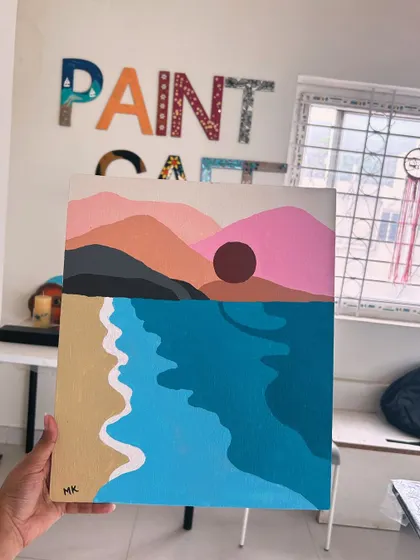 A finished canvas painting of a minimalist beach sunset, created during one of our guided painting sessions at the studio.
