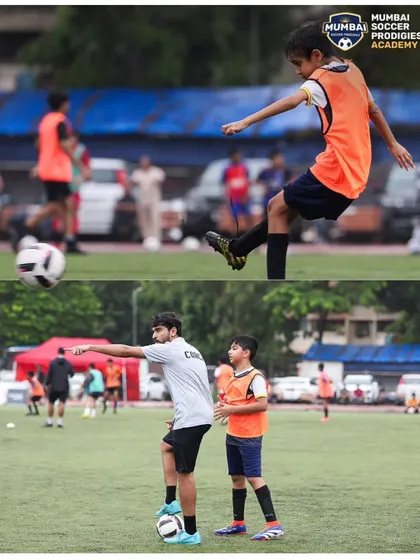 A coach demonstrates proper technique before a young player practices his striking form.