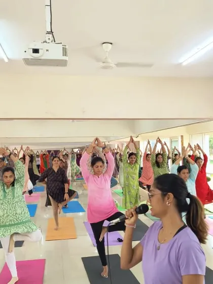 Guiding a large group of employees through Vrikshasana (Tree Pose) during a corporate yoga session. This pose is excellent for improving balance and focus, which are essential skills in the workplace.
