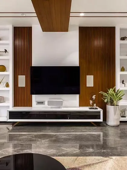 High-gloss marble floors reflect the light in this luxurious living room, where I've paired white display shelves with dark wood panels for a high-contrast look.