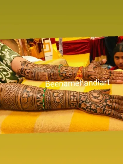 A full-arm bridal design with a mix of traditional motifs like Ganesha and peacocks. This is a great example of a complete bridal package.