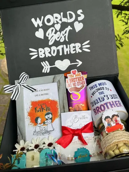 A complete Raksha Bandhan hamper for the "World's Best Brother," including a personalized mug, chocolates, a photo frame, and other goodies in a custom box.