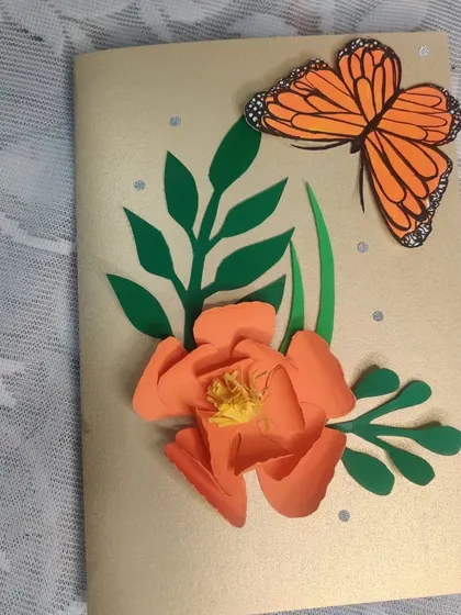 A handmade greeting card I created with 3D paper flowers and a butterfly. These are perfect for when you want to give a card that is also a small piece of art.