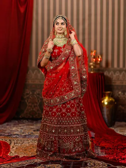 Here is another full view of the magnificent Padmavati-inspired lehenga. The rich red fabric and intricate gold embroidery create a stunning silhouette, perfect for a grand entrance or a royal-themed photoshoot.