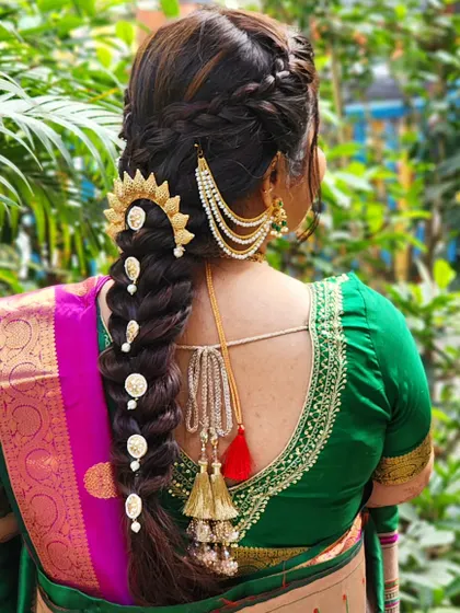 An intricate hairstyle can elevate the entire bridal look. My talented hair team created this stunning, detailed braid, accessorized with traditional gold pieces, which perfectly complements a classic Maharashtrian bridal saree. We design hairstyles that are both beautiful and secure.