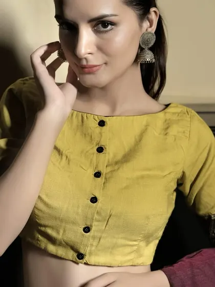 A full view of the yellow cotton boat neck blouse. The front button-down detail and simple silhouette make it a versatile piece for everyday wear.