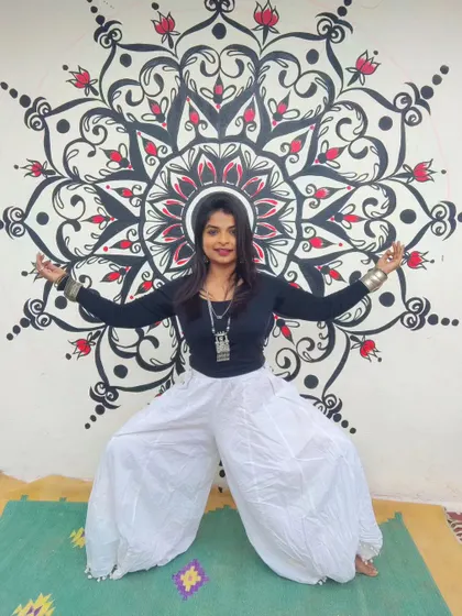 Posing with the finished mandala. The symmetry and flow of the design create a dynamic backdrop, and I love how it interacts with the space.