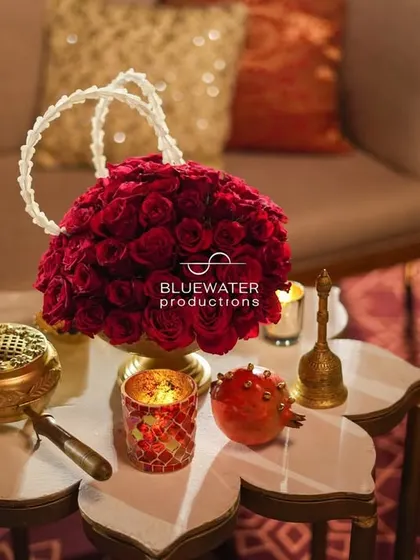 A beautiful arrangement of red roses in the shape of a handbag, complete with a handle made of jasmine, showcasing our creative floral artistry.