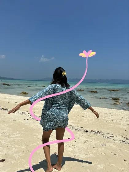 A feeling of freedom on the beach, captured with a simple pink flower doodle that seems to be flying in the wind.