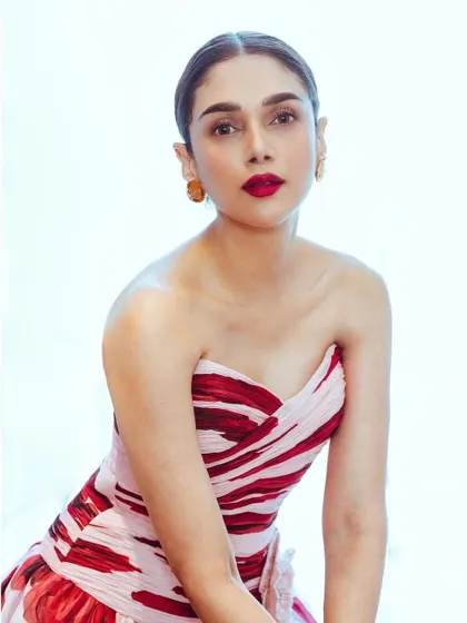 A close-up portrait in the Gauri & Nainika gown, showing the classic red lip and elegant updo that completed this Audrey Hepburn-inspired look.