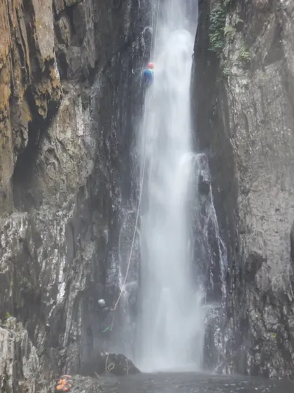 A full view of the rappel down one of the main drops in Knotty Canyon. The force of the water is immense, which is why proper technique is critical.