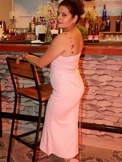 A side view of the pink dress, showing the corset-style tie-up detail on the back.