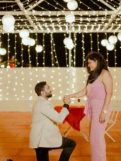A surprise proposal under a canopy of lights. I help couples plan these moments to ensure the setup is perfect and the memory is captured beautifully.