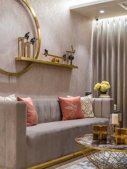 This living room corner is all about quiet opulence. We paired a plush grey sofa with gold accents on the coffee table and wall decor, creating a look that is luxurious yet tastefully restrained.