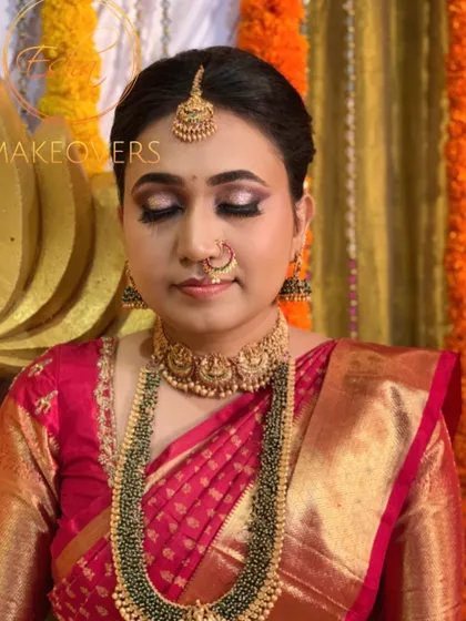 For this Muhurtham look, we went with bold, glittery eyeshadow and a subtle lip to balance the look. It pairs perfectly with her heavy green beaded jewellery and Kanchipuram saree.