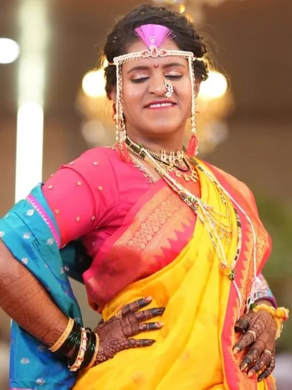 Confidence and joy. This bride is striking a pose, and her dark mehendi stain is the perfect accessory to her vibrant wedding attire.