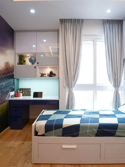 A closer look at the kids' bedroom, showing the clever use of space. The bed includes under-drawer storage, and the headboard has built-in shelving for books and treasures, making it a perfect room for a growing child.