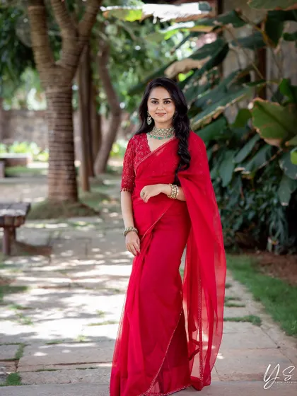 A full-length shot of the red organza saree, perfect for a party or festive occasion.
