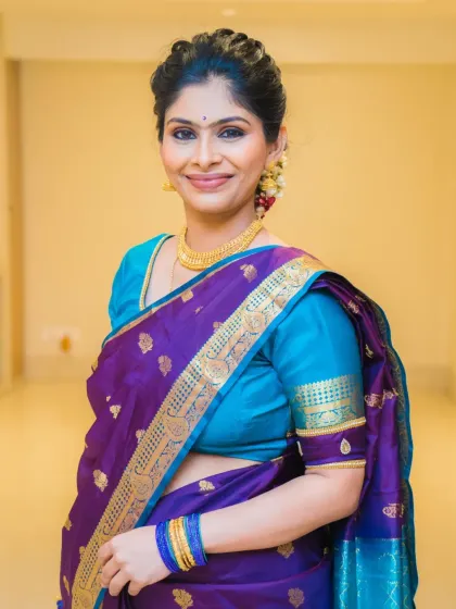 Keerthana looking elegant and beautiful for the naming ceremony. The purple and blue saree is a stunning combination.