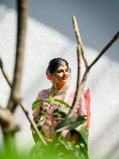 A creative bridal portrait of Srushti. I shot this through some bare branches to create an interesting foreground, framing her beautifully against the white wall and morning light.