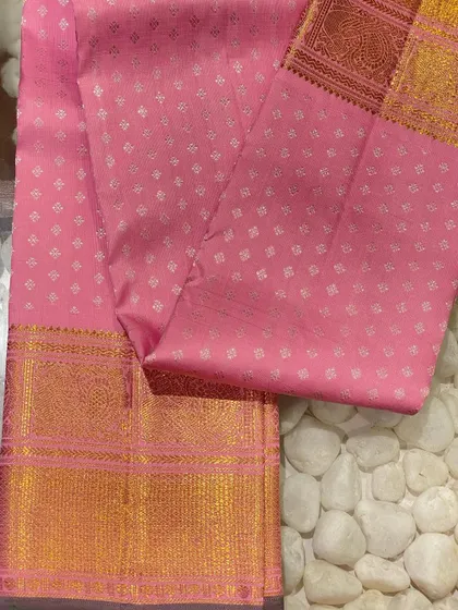 A soft pink Kanjeevaram blouse piece with delicate silver butti work. This is a versatile piece that pairs beautifully with many different silk sarees.