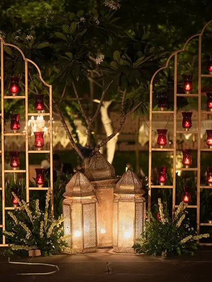 Stained glass candle panels in the shape of traditional arches, adding a pop of color and intricate detail to the Sufi night decor.