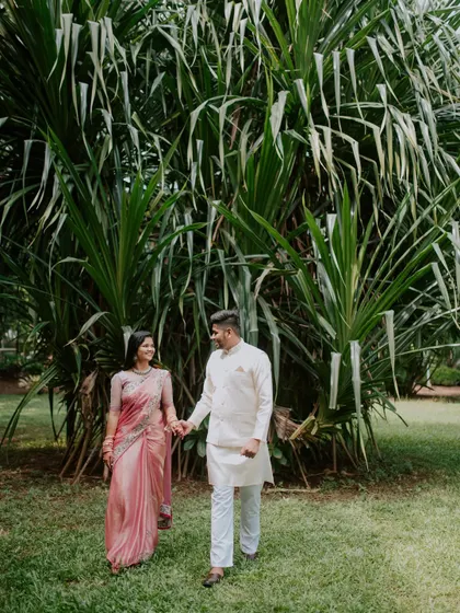 A happy walking shot of the newly engaged couple in a park.