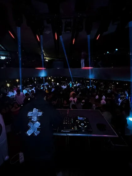 A view from the back of a massive club, showing the impressive scale of the venue and the crowd I'm playing for.