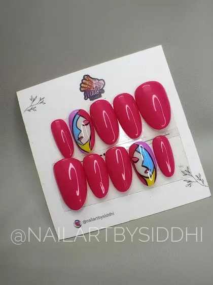 An artistic press-on set inspired by Picasso's line art. This design features abstract faces on two accent nails, paired with a vibrant solid pink.