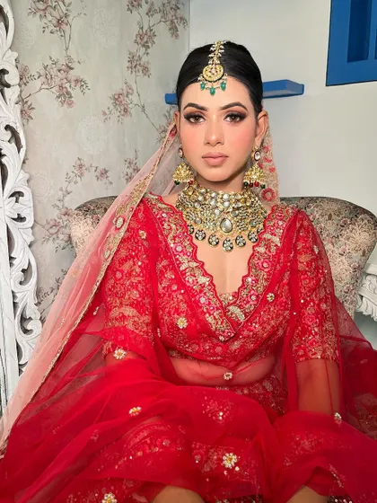 Seated portrait of my bride, exuding grace. The makeup is designed to look impeccable from every angle, ensuring she is picture-perfect throughout her wedding day ceremonies.