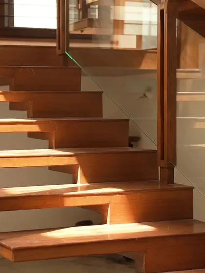 A duplicate of ID 35, this image captures the beautiful play of light and shadow on the wooden steps. Our design ensures that even functional elements contribute to the home's overall aesthetic.