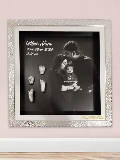 For a modern and heartfelt tribute, I can combine your family's first portrait with the delicate silver casts of your baby’s hands and feet. This design features a stunning silver textured frame and a classic black and white photograph, creating a sophisticated piece of art for your home.