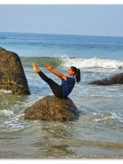 Finding my balance with a teaser pose by the sea. The mat can be anywhere, and the principles of core control and stability travel with you.