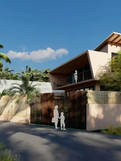 An exterior view of the Corgao villa from the street, showing its modern form and use of natural materials. The design respects its context, with a scale and presence that feels both contemporary and at home in Goa.