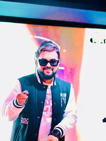 Tapping into the universal language of rhythm. A smiling, happy shot of me pointing to the crowd from the DJ booth.