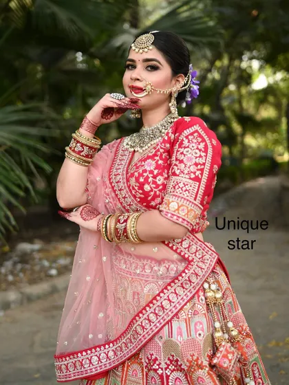 A full view of this stunning bride in her red and pink rental lehenga. The entire look, from the outfit to the complete jewellery set, is available at my store.
