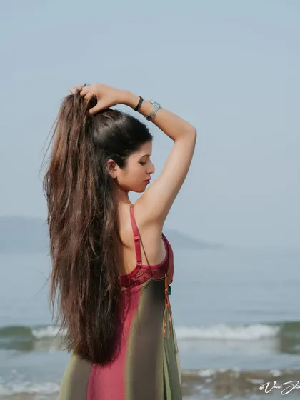 This shot highlights the model's long hair, a key feature. It's a simple yet effective pose for beauty and hair-focused portfolio images, taken during our Alibag beach shoot.
