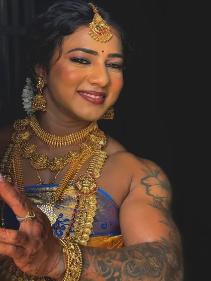 A welcoming gesture in full traditional attire. This photo shows my friendly and approachable side, inviting you to see the person behind the muscles.